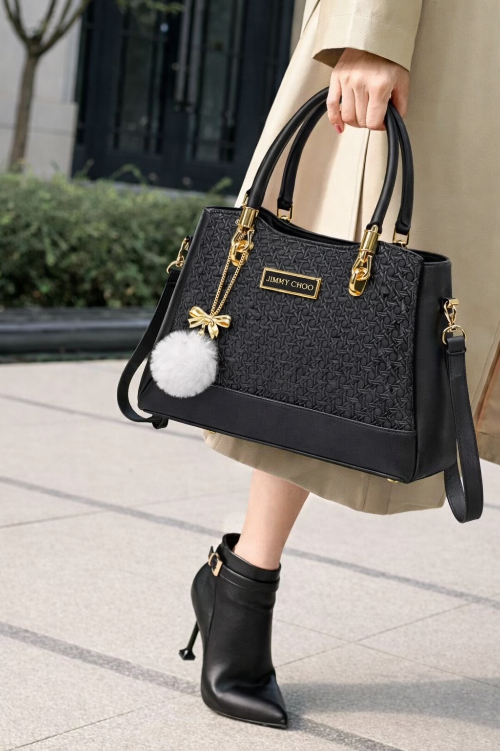 Elegant Designer Handbag with Gold Hardware & Pom-Pom Charm