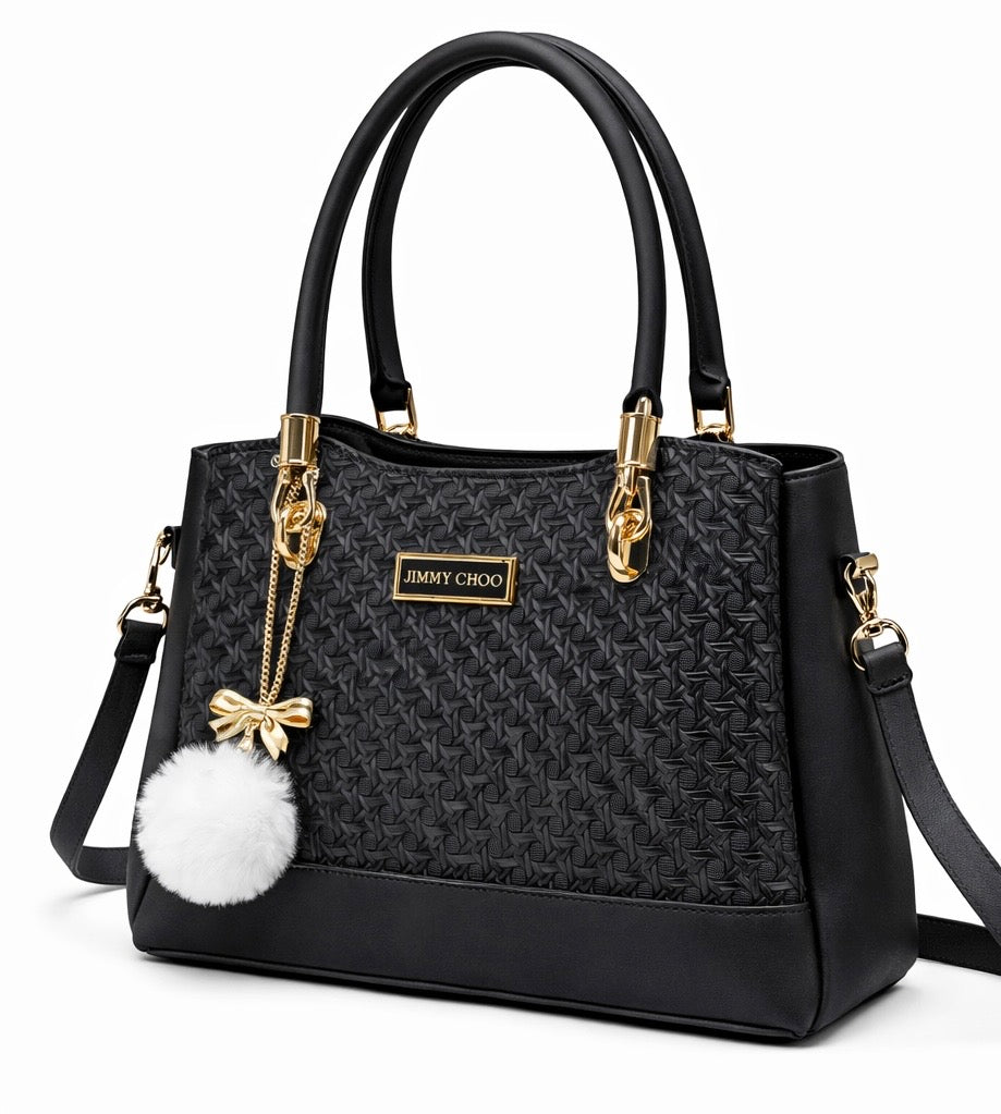 Elegant Designer Handbag with Gold Hardware & Pom-Pom Charm