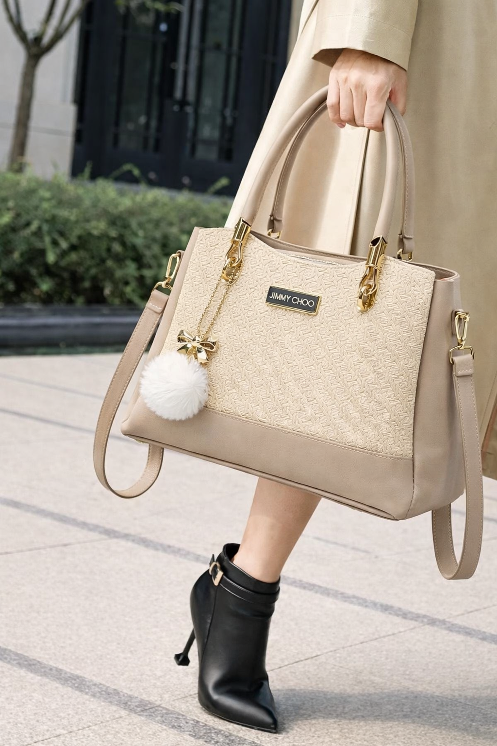 Elegant Designer Handbag with Gold Hardware & Pom-Pom Charm