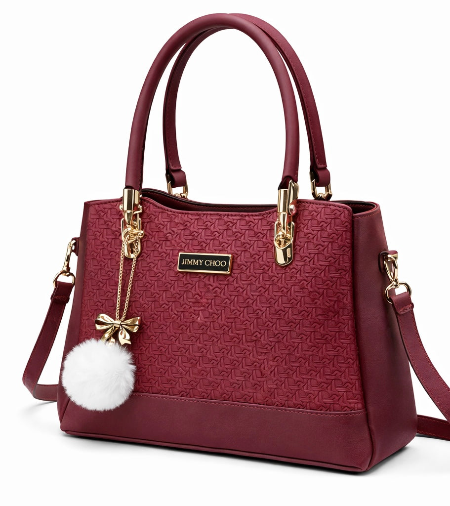 Elegant Designer Handbag with Gold Hardware & Pom-Pom Charm