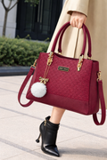 Elegant Designer Handbag with Gold Hardware & Pom-Pom Charm