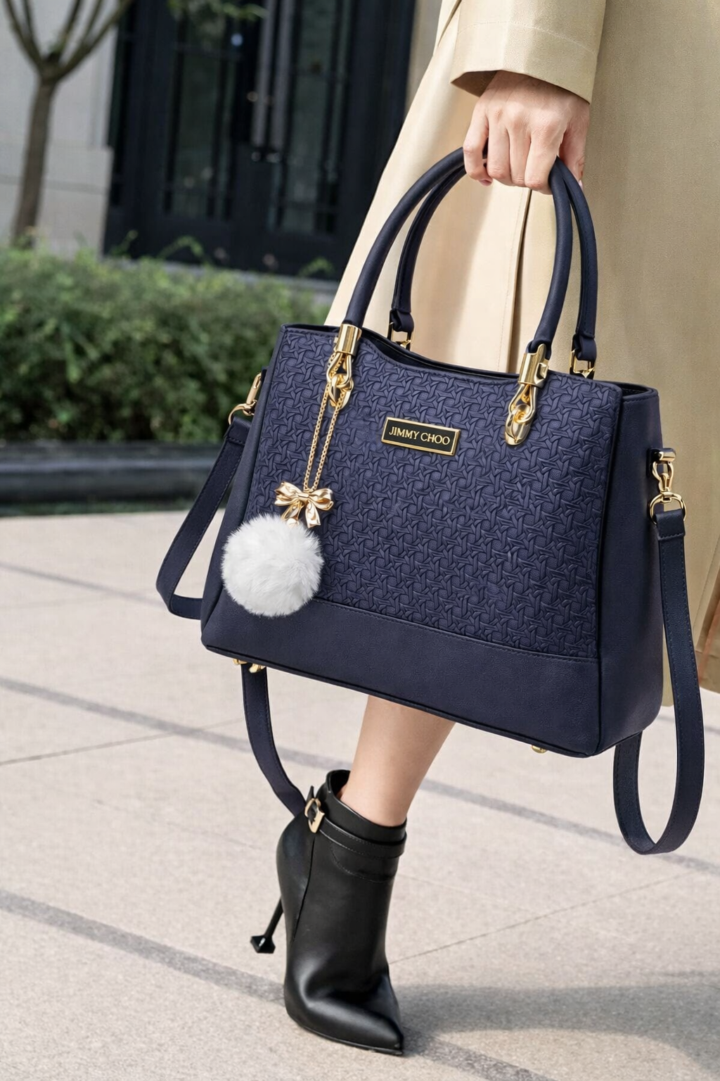 Elegant Designer Handbag with Gold Hardware & Pom-Pom Charm