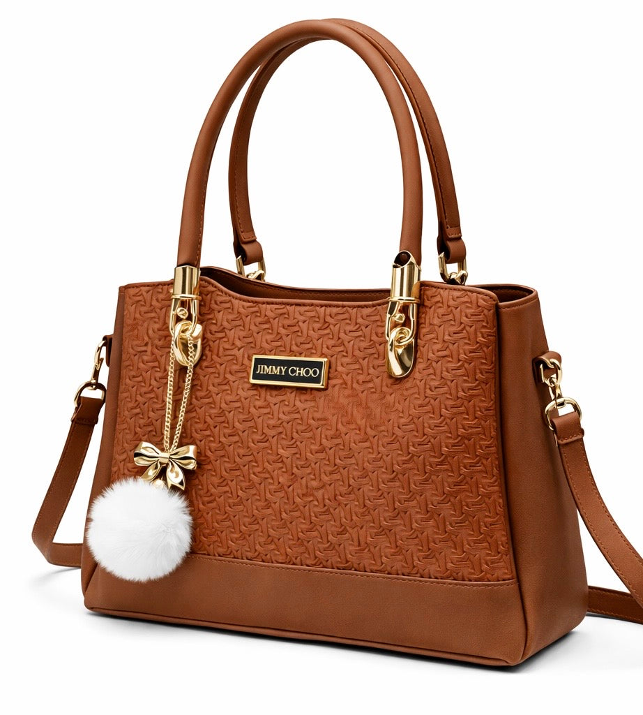 Elegant Designer Handbag with Gold Hardware & Pom-Pom Charm